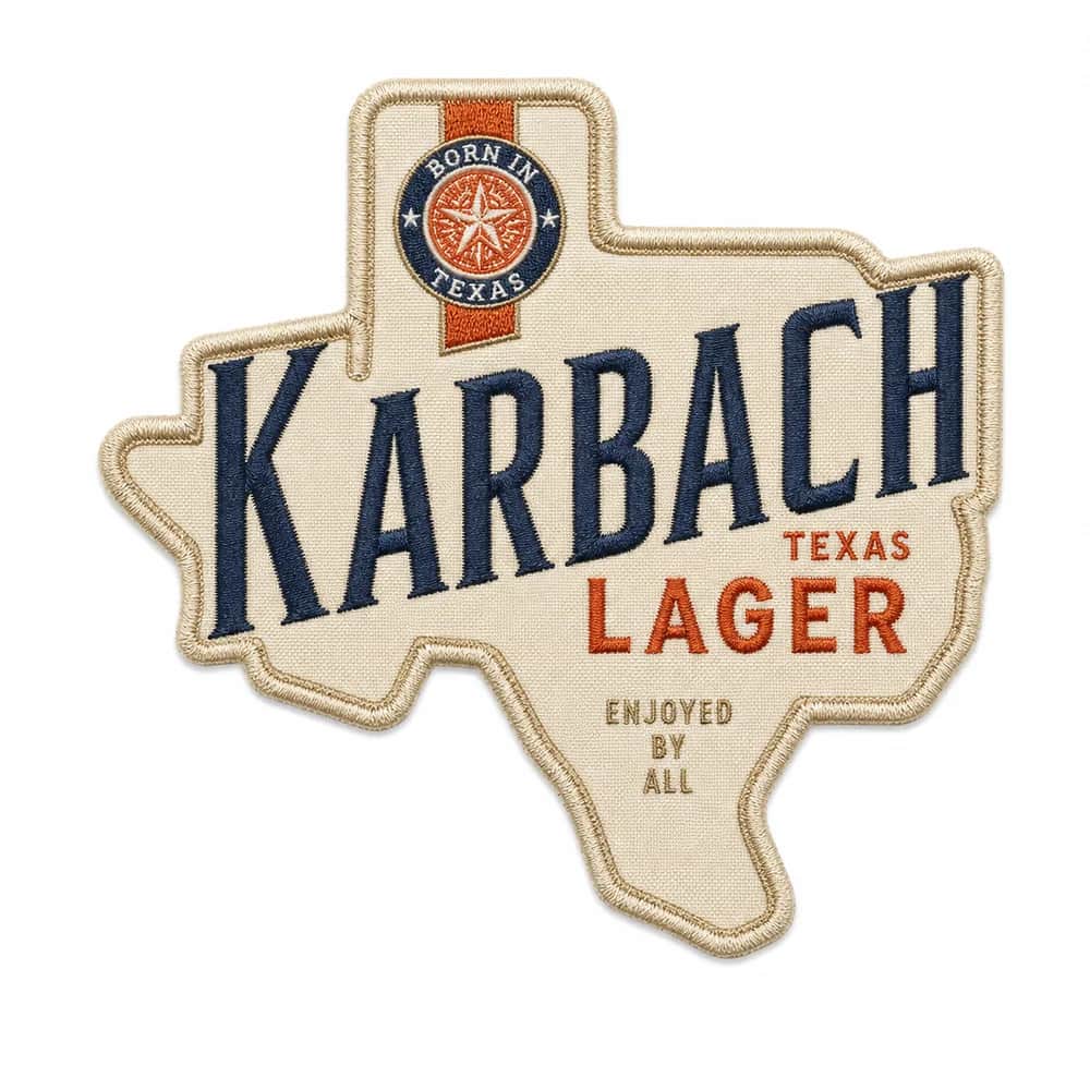 Woven Karbach Brewing patch cut to the shape of Texas, cream ground with navy Karbach lettering, orange Texas Lager type, and a Born in Texas star roundel