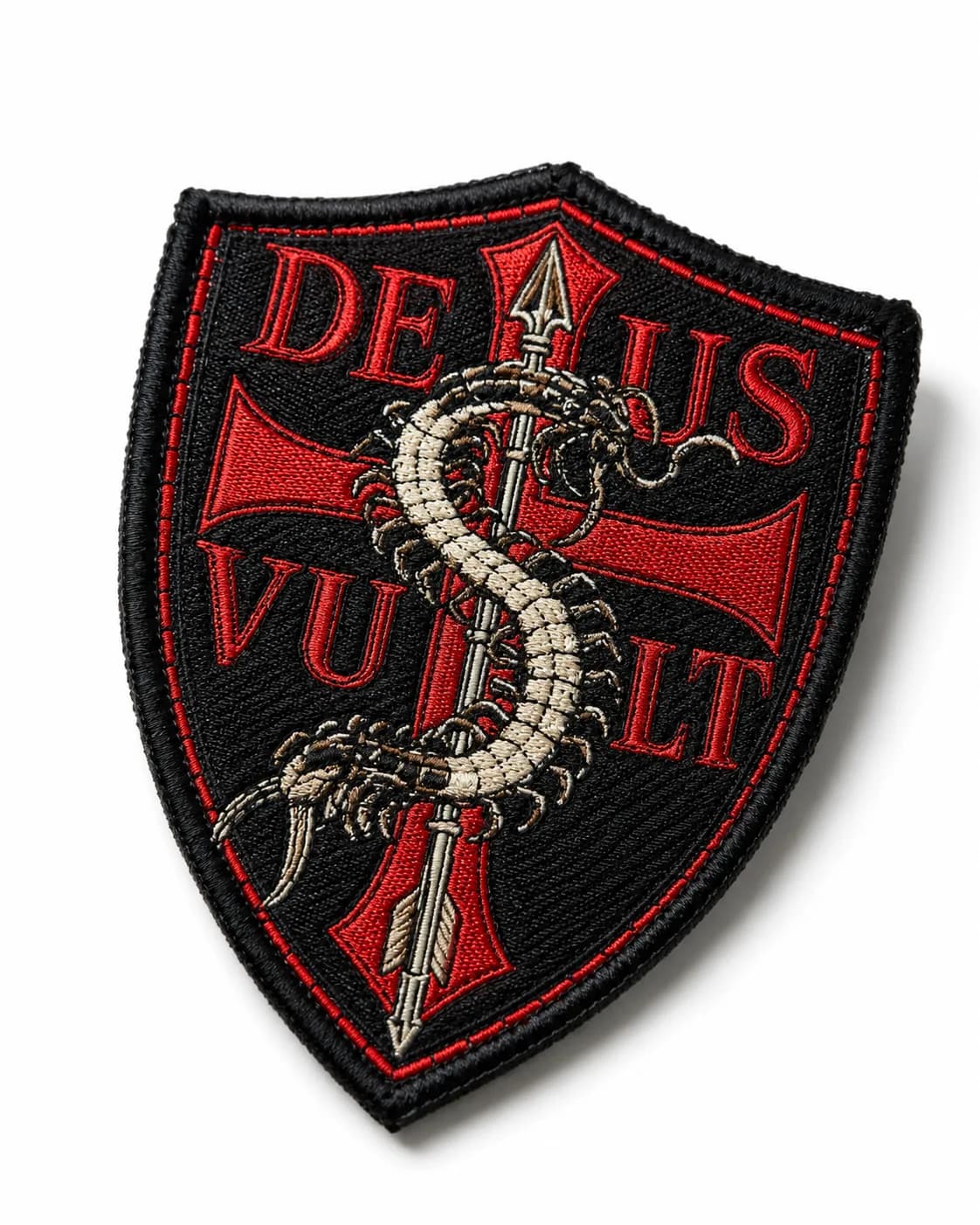 Shield-shaped woven patch holding fine detail — individual insect legs and a thin keyline that embroidery thread could not reproduce at this size